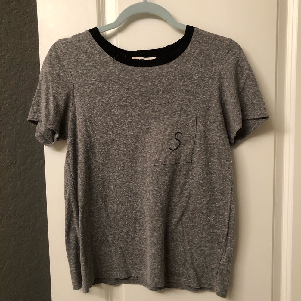 Gray T-shirt with an S on the pocket